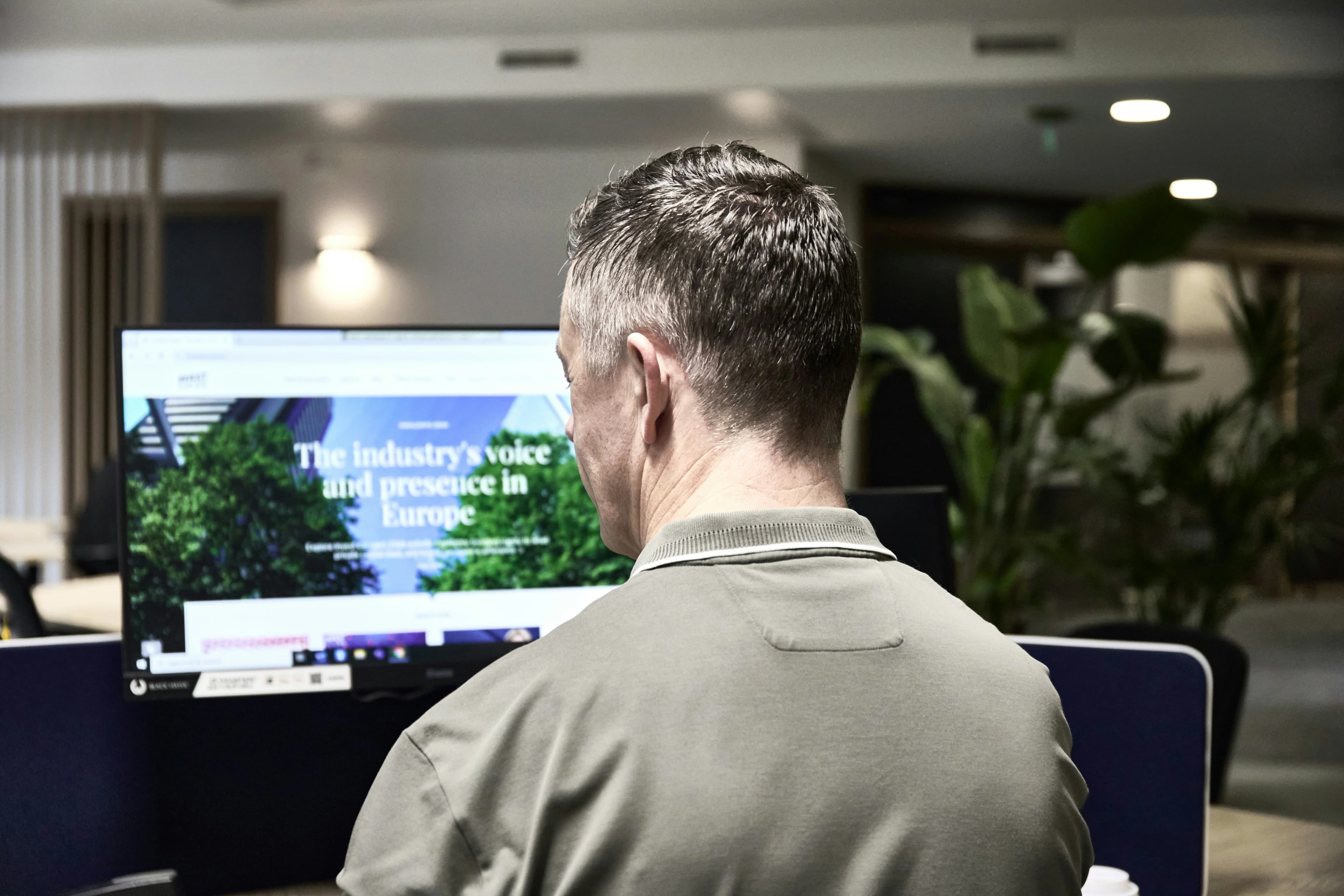Man working on a computer in an office.