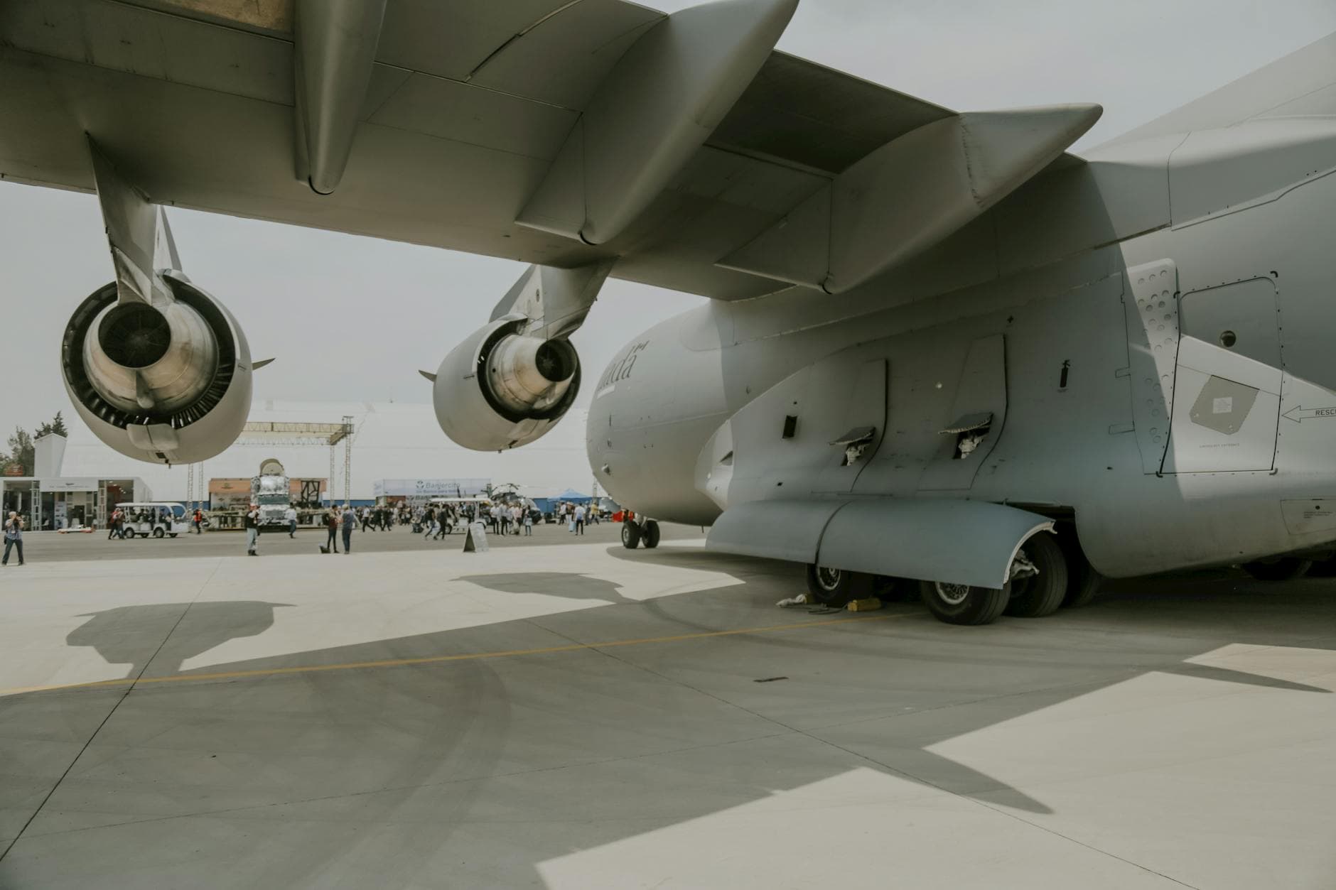 Close-up of C-17 Globemaster on display at outdoor airforce event showcasing aviation technology.