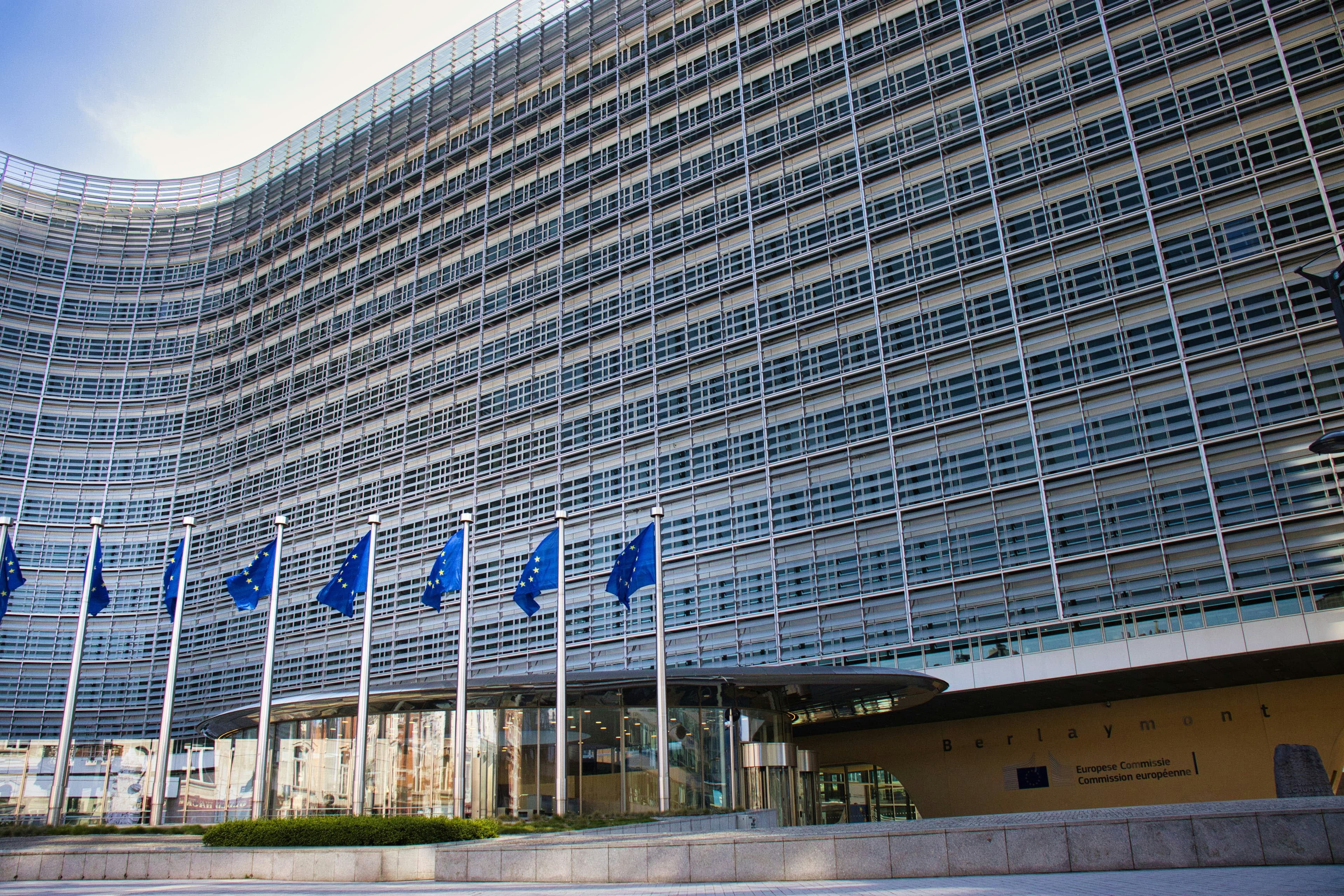 Modern glass building with european union flags