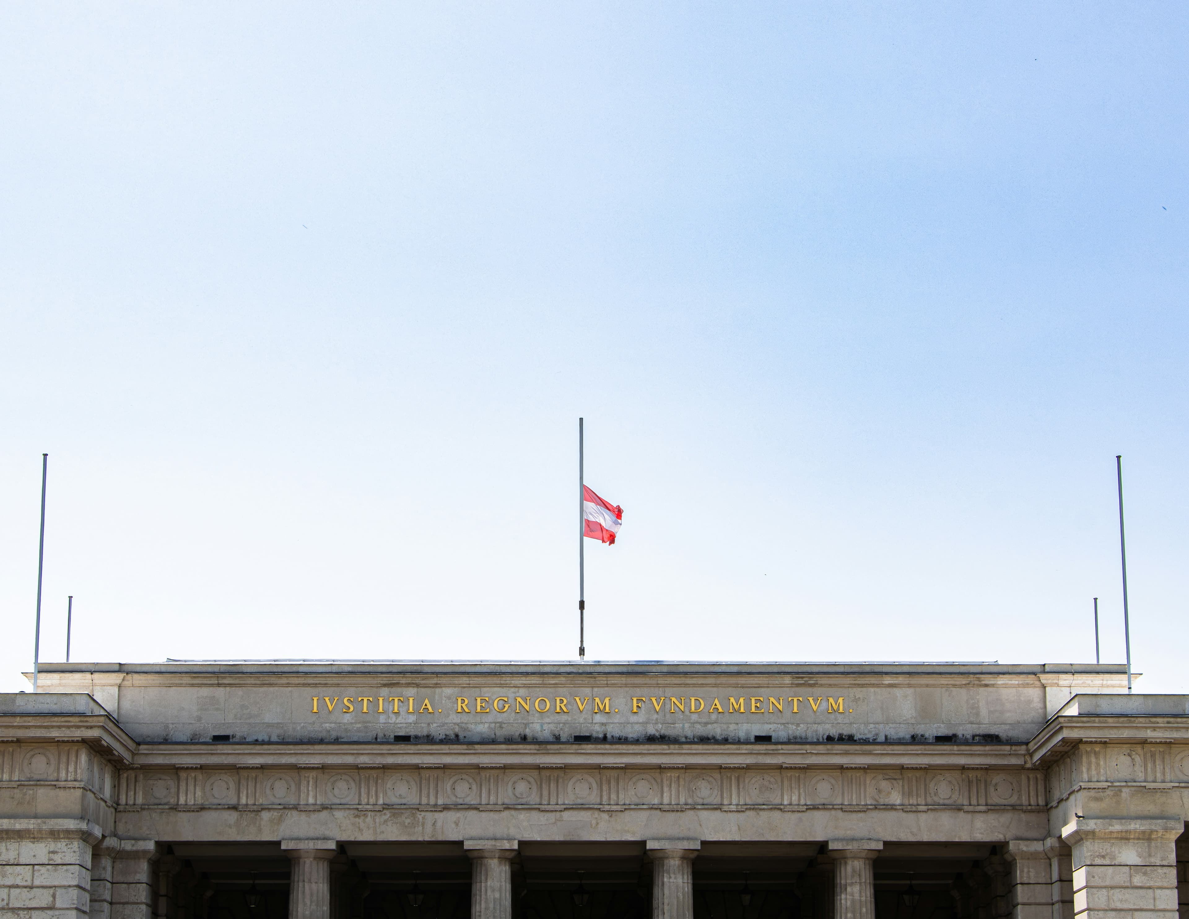 Austrian flag at half mast on building