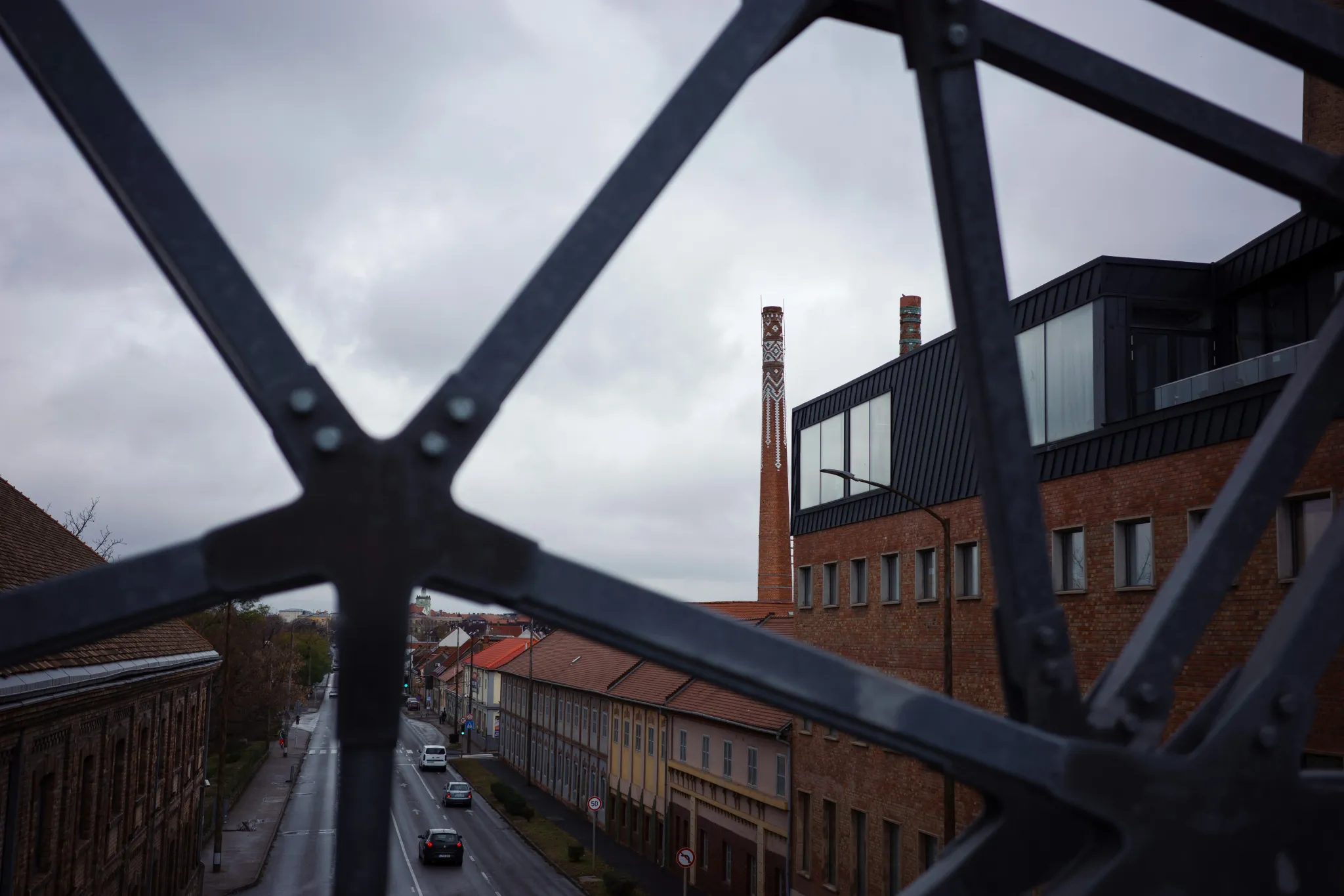 Industrial buildings with a smokestack under a cloudy sky