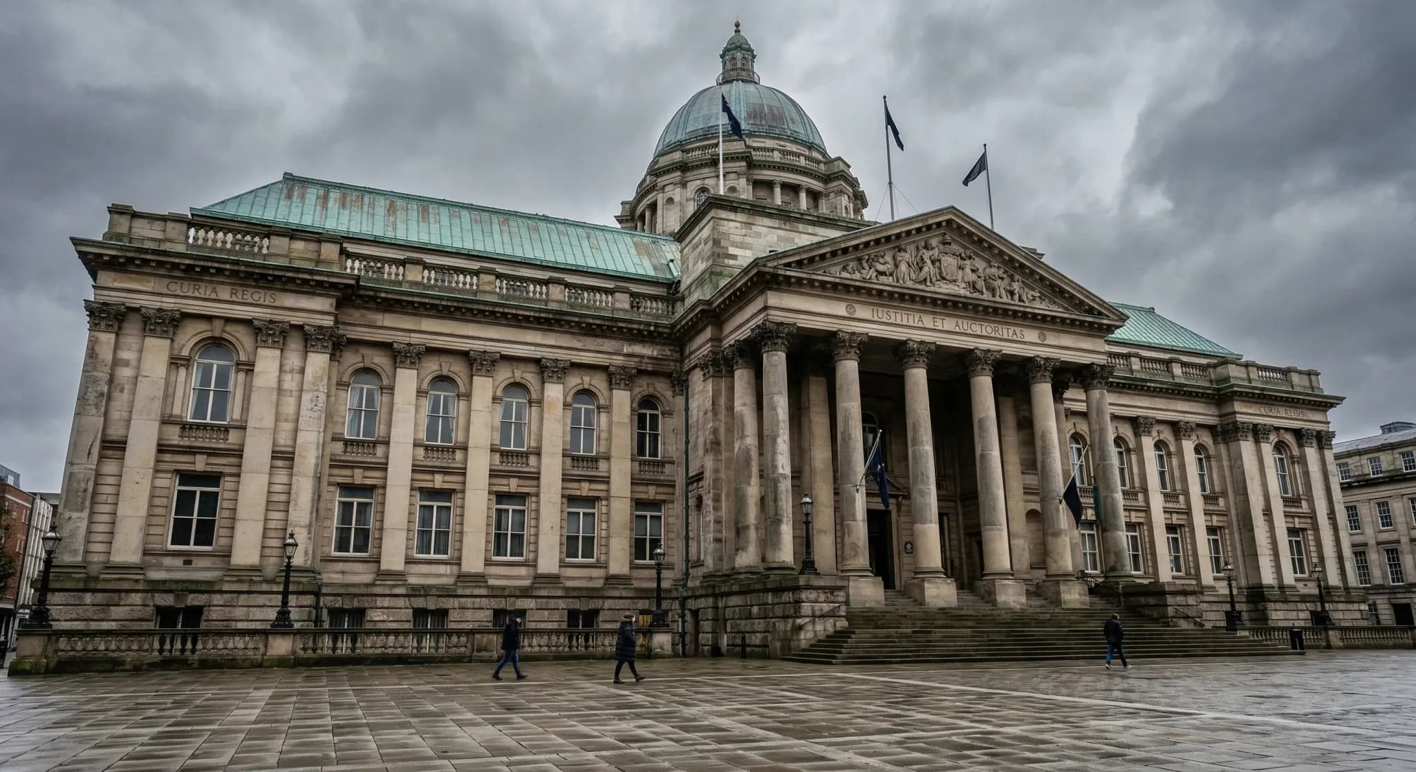 A photorealistic wide-angle shot of a grand neoclassical government building with a weathered copper roof and stone pillars, seen from a low angle against a grey, overcast sky. The atmosphere is solem