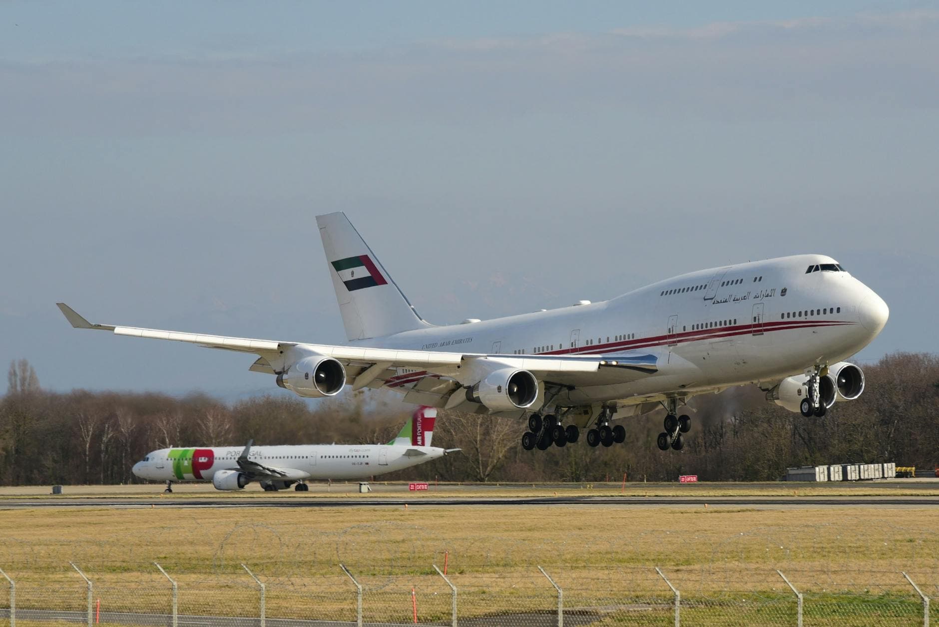 Two commercial aircraft landing at Geneva Airport on a clear day, showcasing international aviation.