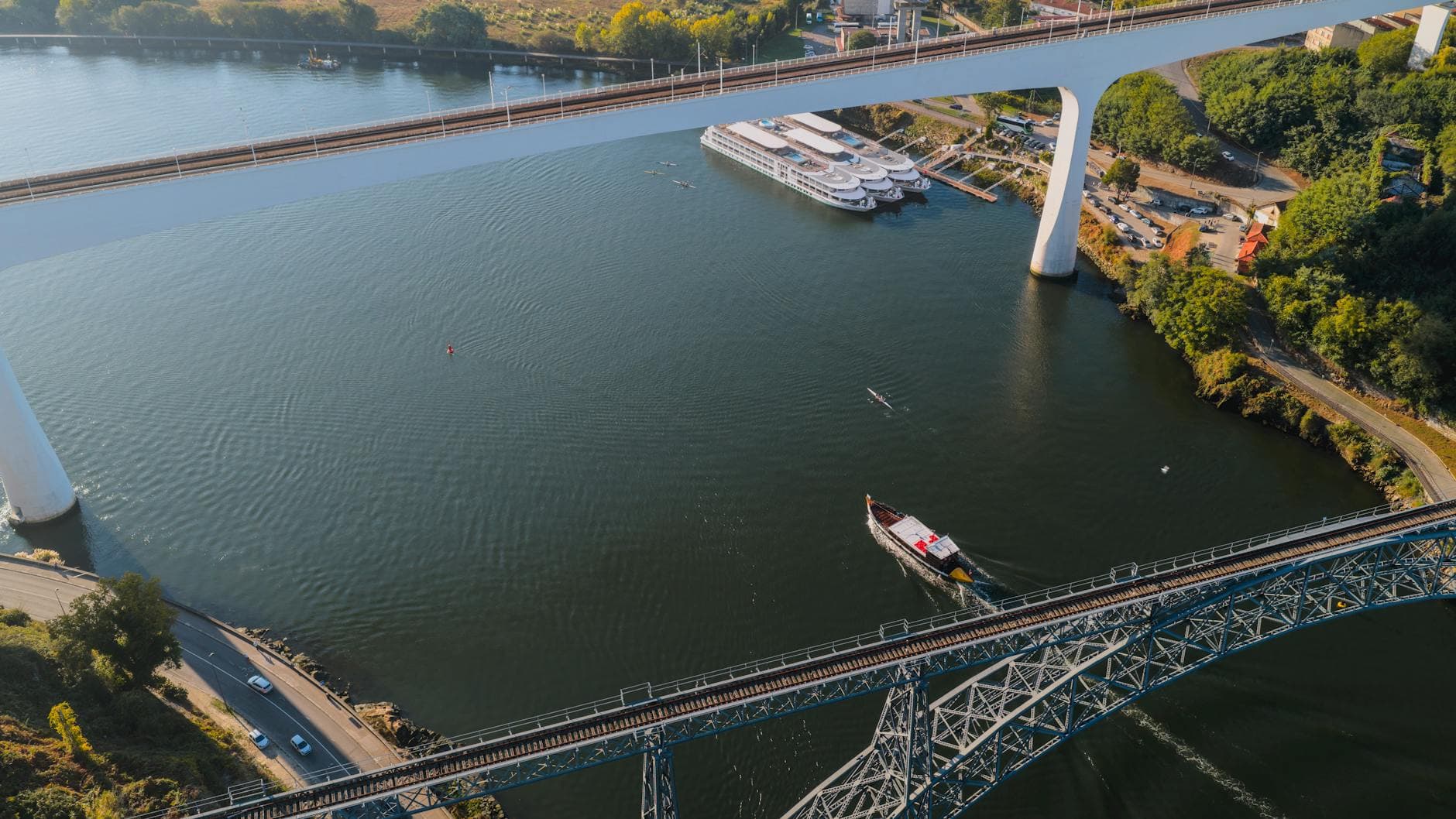 Drone shot of Porto, Portugal, showcasing the city's iconic bridges over the Douro River.