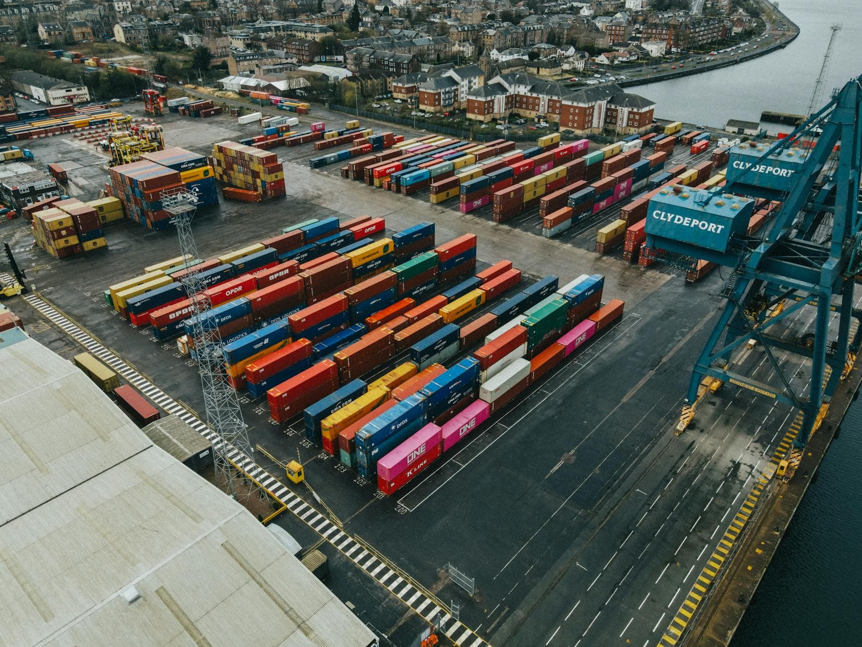 Colorful cargo containers stacked at Clydeport terminal, Scotland, showcasing vibrant logistics scene.