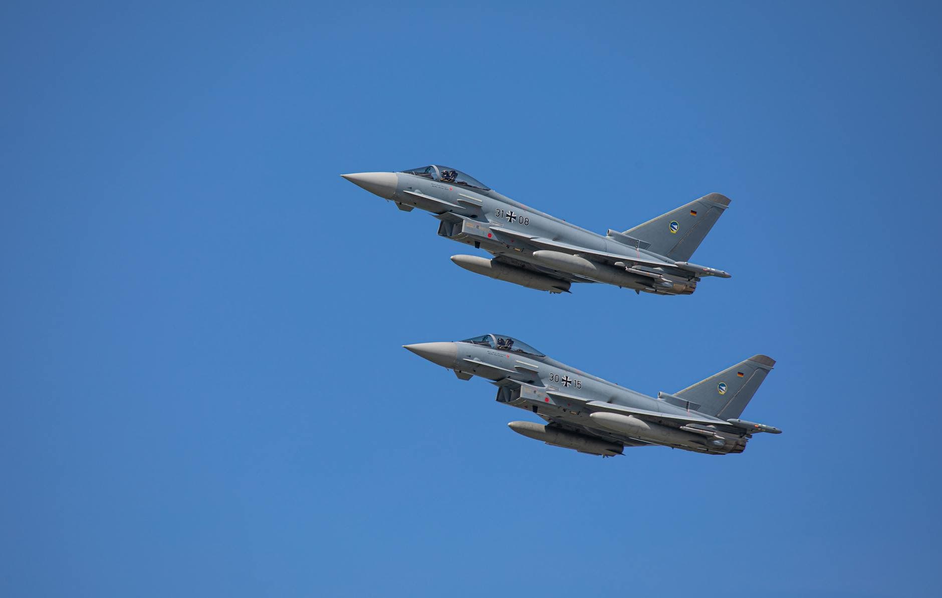 German Air Force Eurofighter Typhoons soaring in clear Slovakian sky.