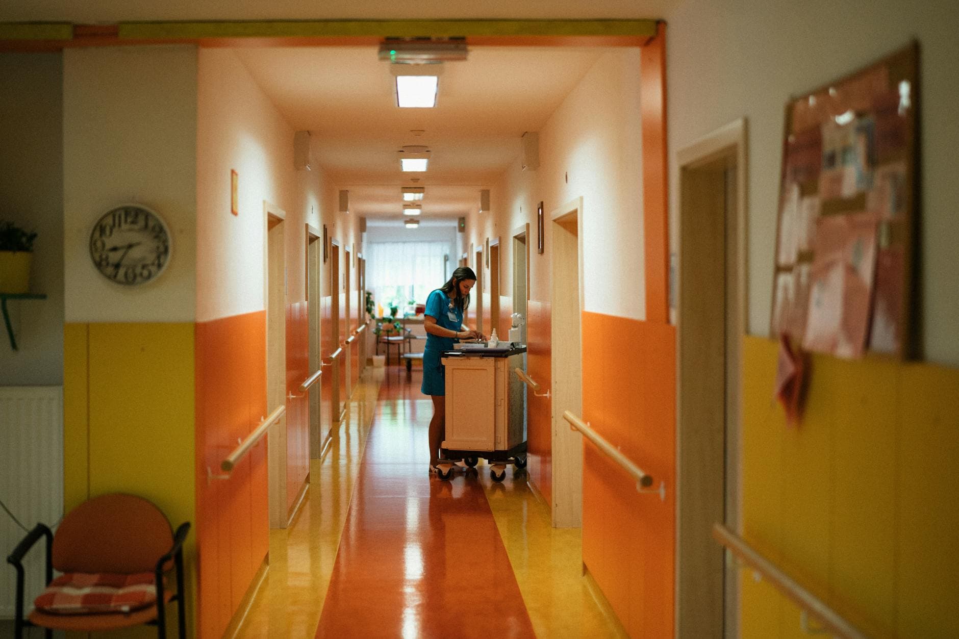 A nurse attending to duties in a colorful hospital corridor in Karviná, Czech Republic.