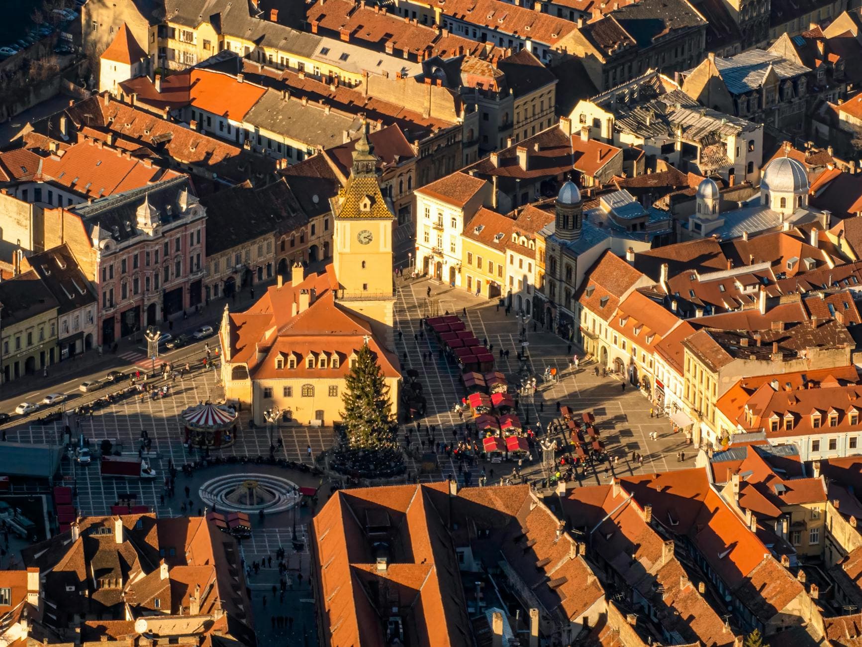 A picturesque aerial view capturing the charm of a historic old town square at sunset.