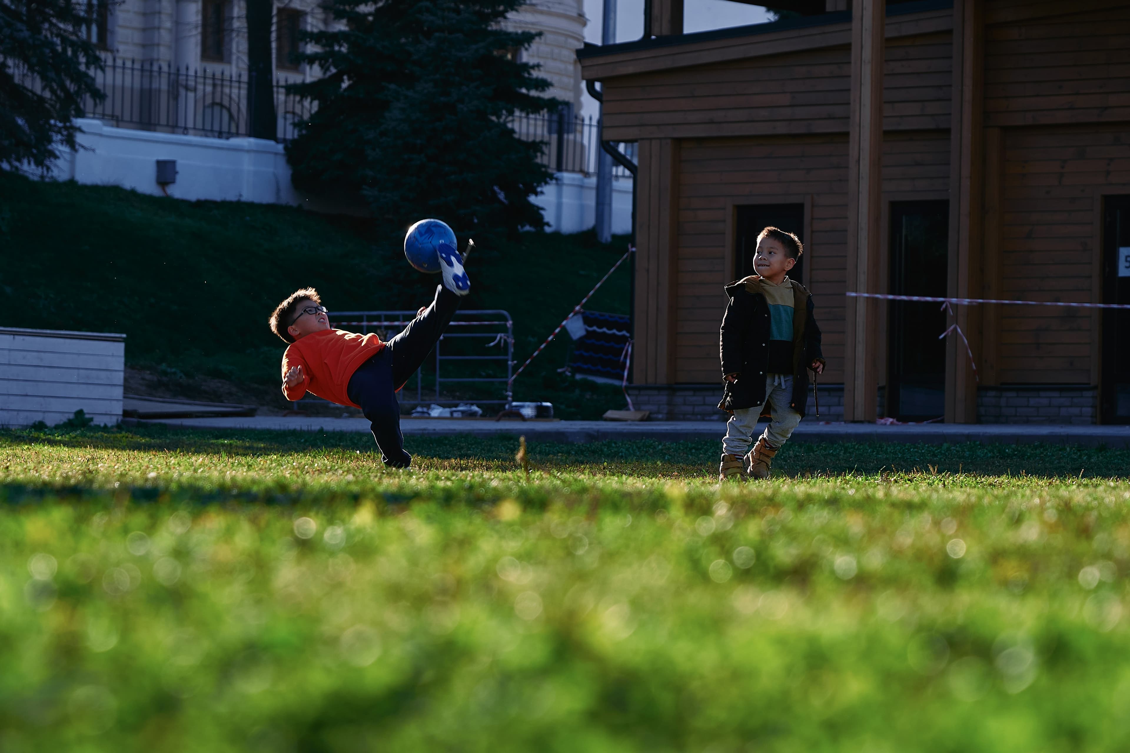 a small child swinging a bat at a ball